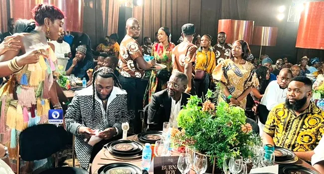 Burna Boy Honours Grandfather Benson Idonije at 90th Birthday